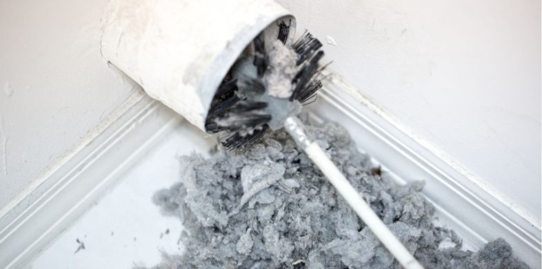 Lint being cleaned out of a dryer vent